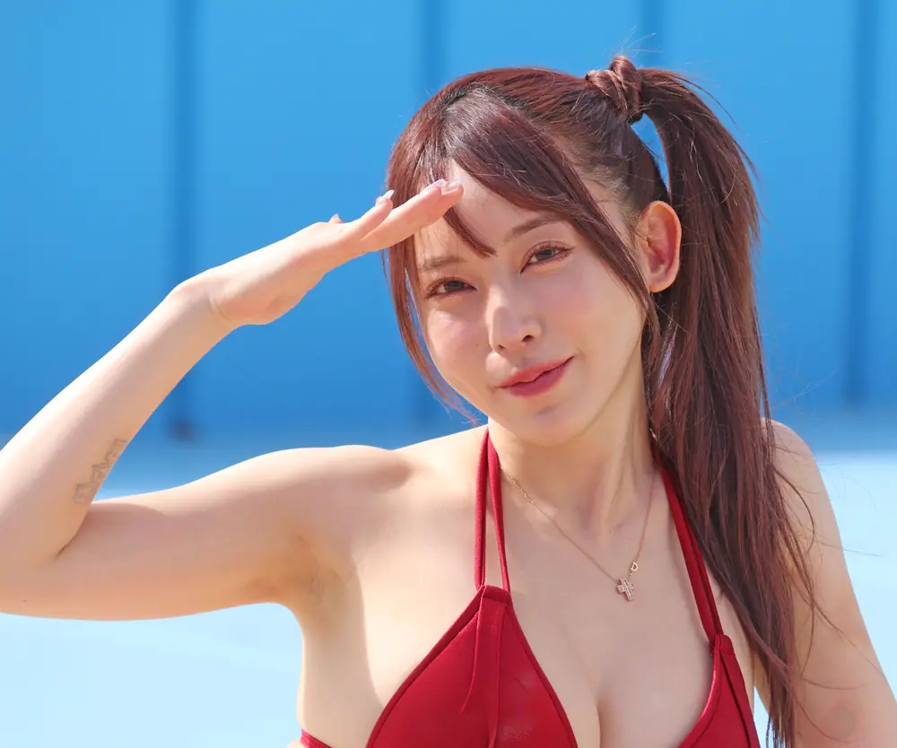Alice Nanase สวมชุดว่ายน้ำสีแดงและยกมือบังแดด