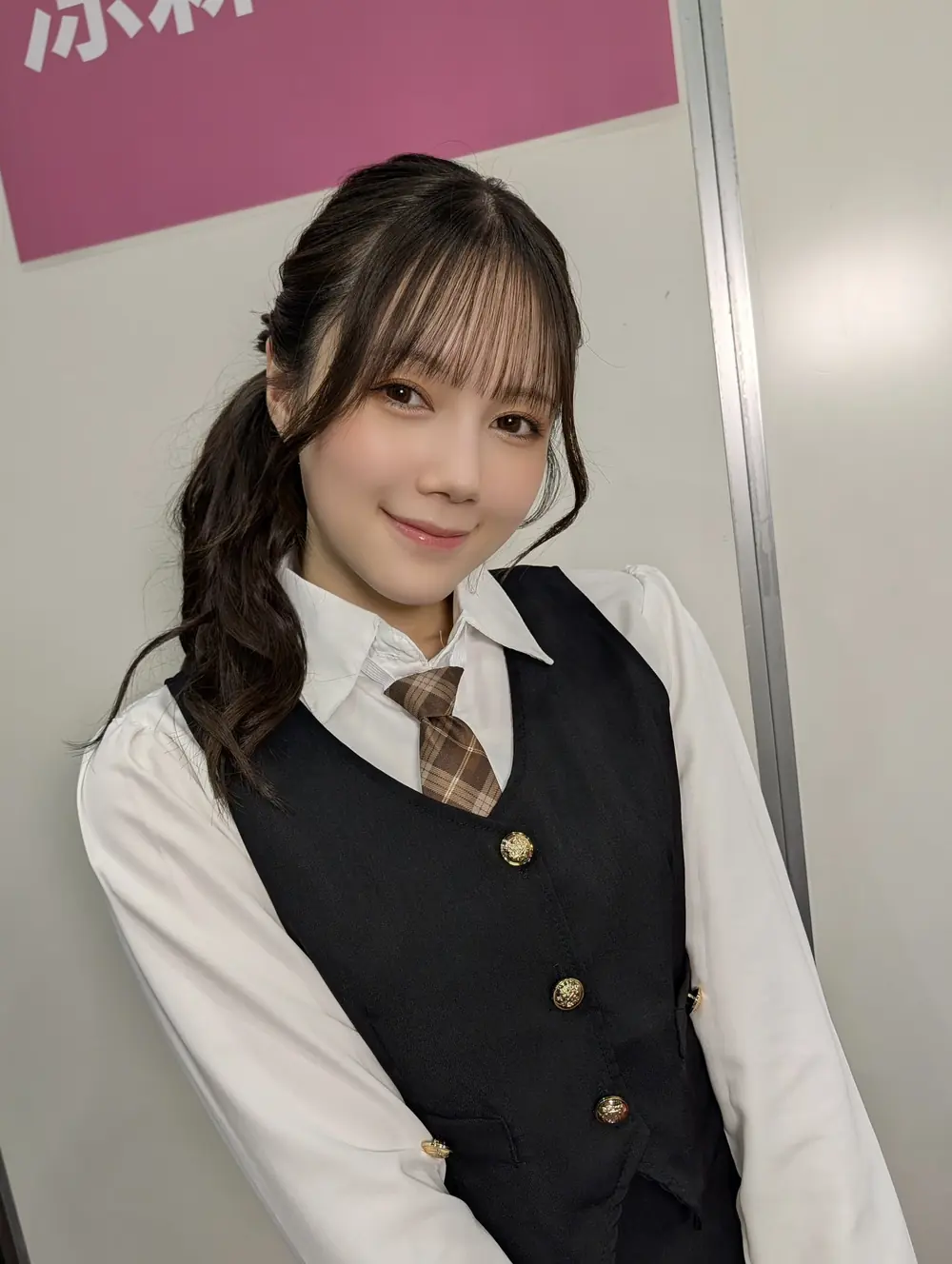 Remu Suzumori สวมเสื้อกั๊กสีดำกับเสื้อเชิ้ตและเนกไท