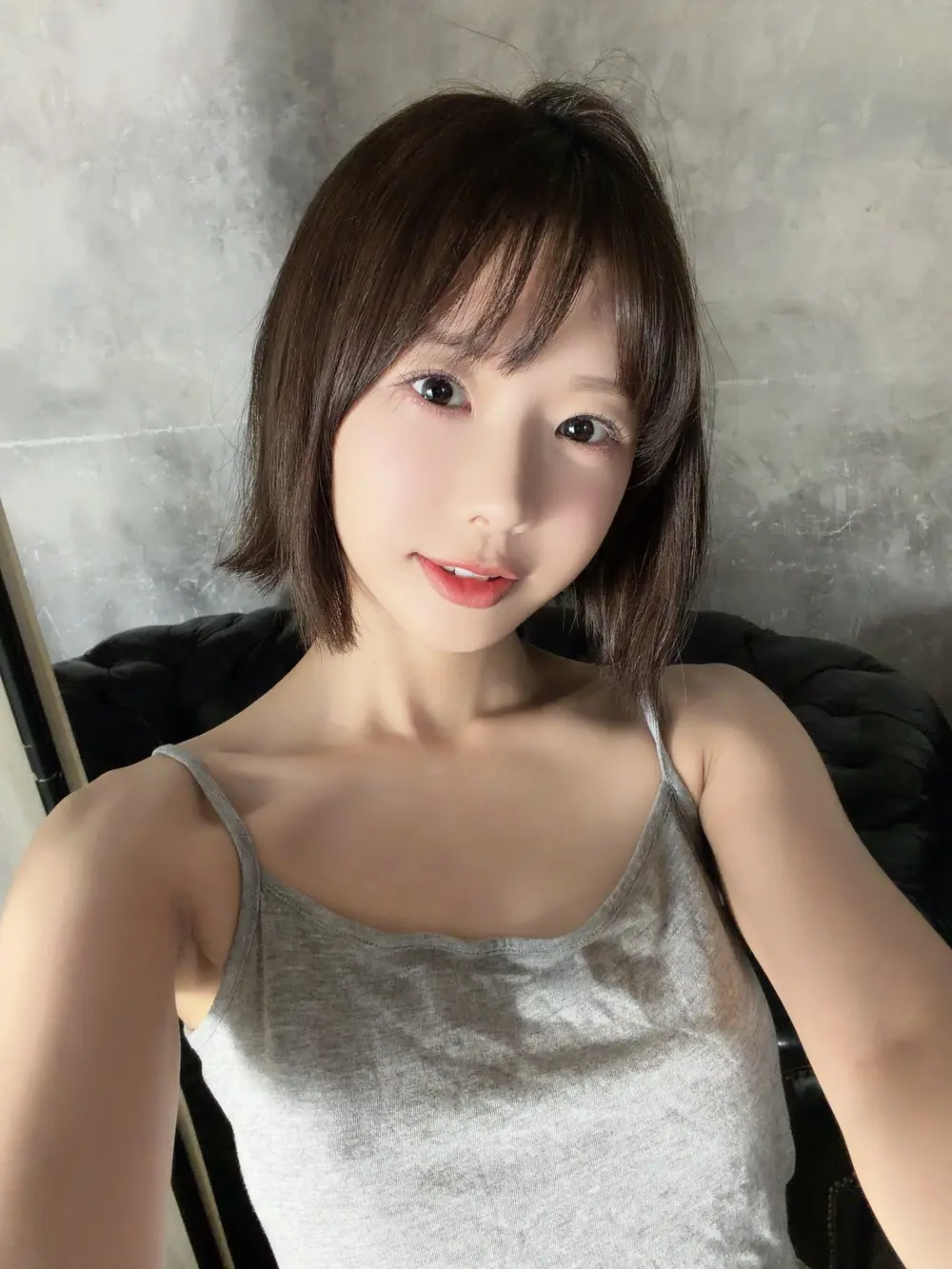 Rio Kuriyama สวมเสื้อสายเดี่ยวสีเทาและยิ้มให้กล้อง