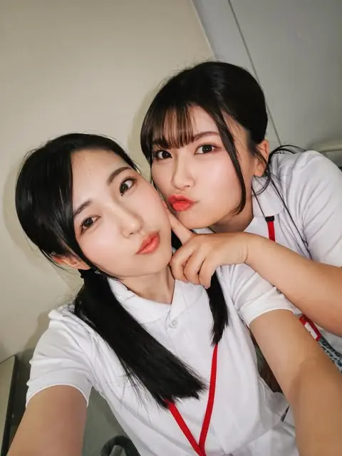 Hikaru Minazuki in a white blouse with another person