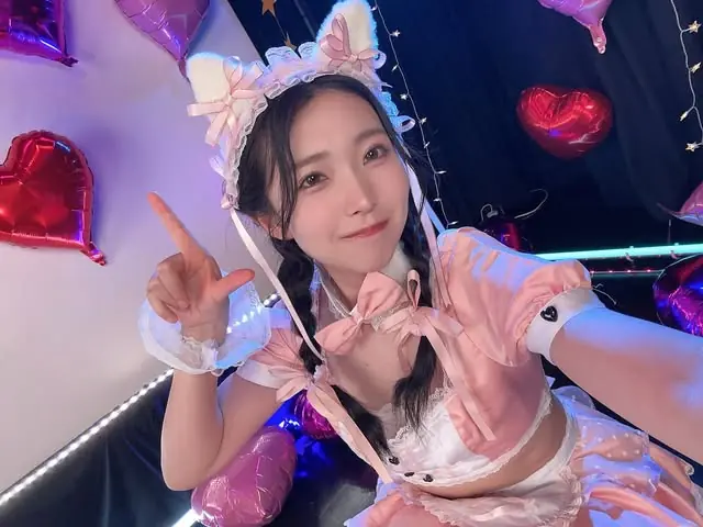 Hikaru Minazuki in a pink outfit with balloon decorations