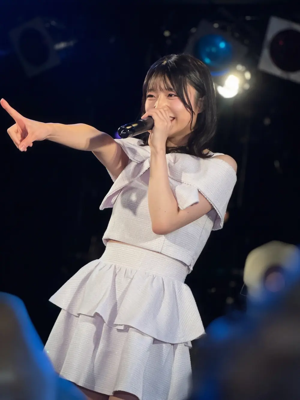 Kira Kira สวมเดรสสีม่วงอ่อนถือไมโครโฟนร้องเพลงบนเวที