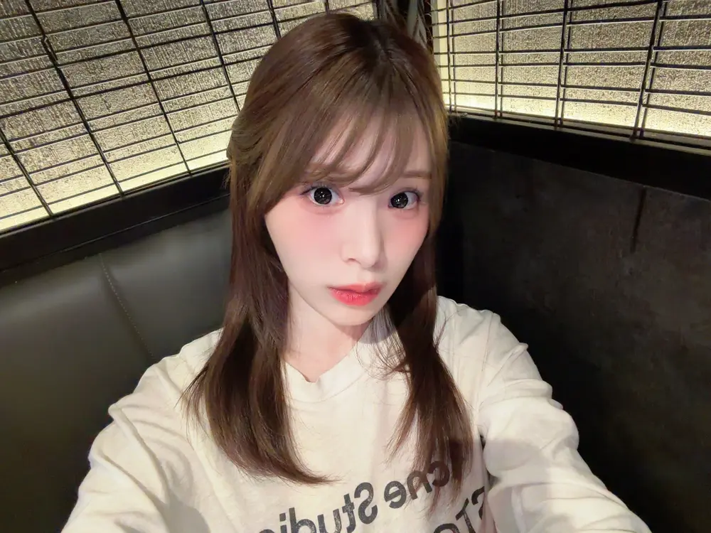 Nano Ogasawara ถ่ายภาพเซลฟี่ในเสื้อสีอ่อนภายในอาคาร