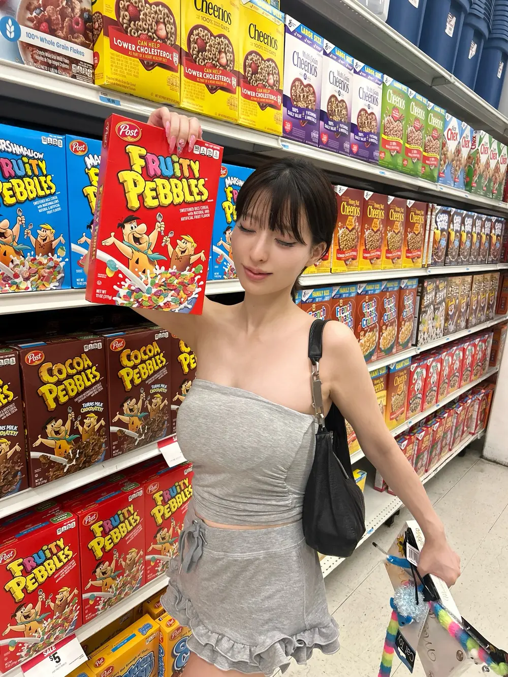 Akari Momoka ถือกล่องซีเรียลในซูเปอร์มาร์เก็ต