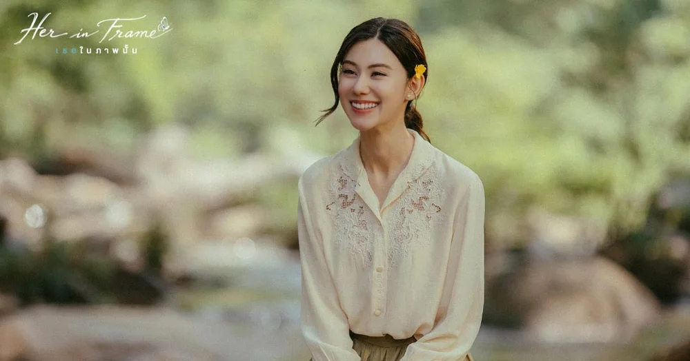 ภาพจากหนัง Her in Frame นักแสดงนำหญิงยิ้มอยู่ริมลำธารท่ามกลางธรรมชาติ